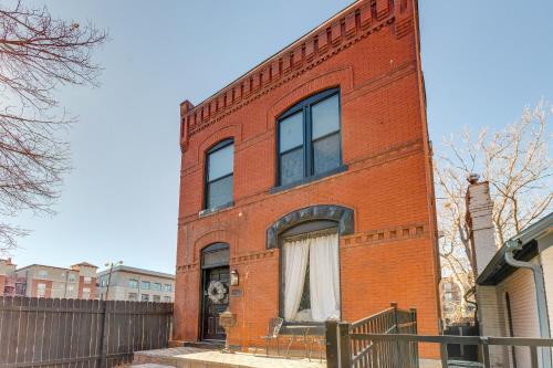 a red brick building with a white curtain in the window at 1 Mi to Coors Field Cozy Denver Studio with Patio! in Denver