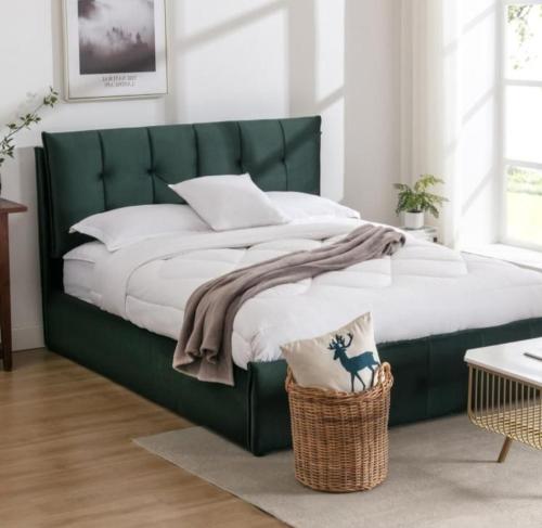 a bed with a green headboard in a bedroom at ESCAL'HOME appart design au pied de l'aéroport, parkings in Blagnac