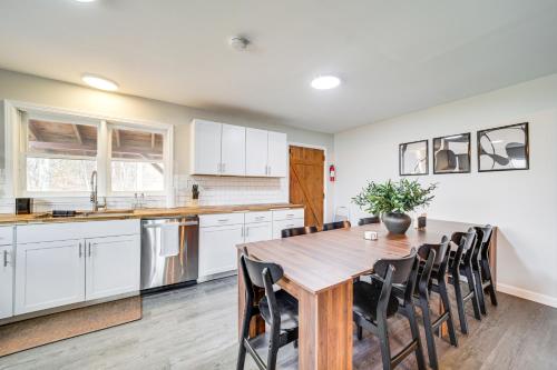 a kitchen and dining room with a wooden table and chairs at Hot Tub, Game Room and Fire Pit Canton Log Cabin in Canton