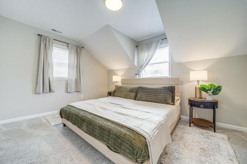a bedroom with a bed and two windows at Hot Tub, Game Room and Fire Pit Canton Log Cabin in Canton