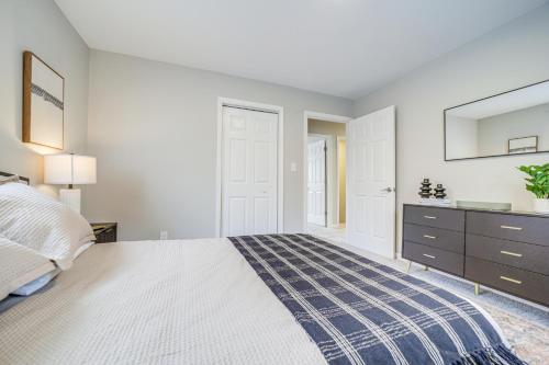 a bedroom with a bed and a dresser and a mirror at Hot Tub, Game Room and Fire Pit Canton Log Cabin in Canton