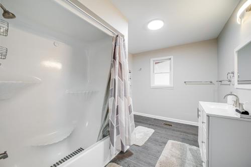 a white bathroom with a shower and a sink at Hot Tub, Game Room and Fire Pit Canton Log Cabin in Canton