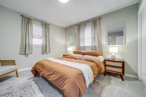 a bedroom with a bed and two windows at Hot Tub, Game Room and Fire Pit Canton Log Cabin in Canton