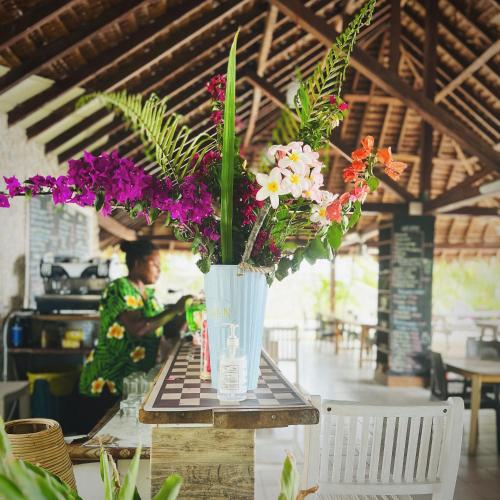 a vase filled with flowers sitting on a table at Tanna Evergreen Resort & Tours in Tanna Island