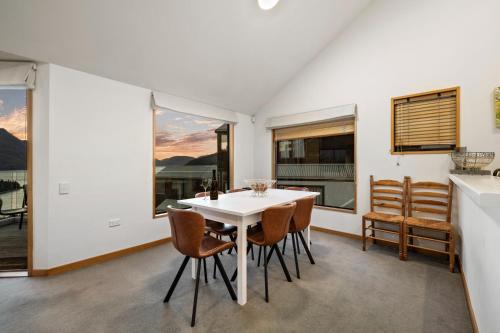 a dining room with a white table and chairs at Sun-filled on Wakatipu in Queenstown