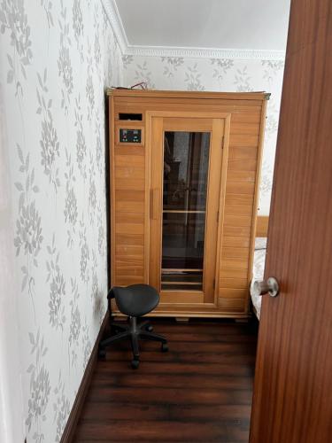 a room with a chair and a door with a window at Macs Belfast Single bedroom in Belfast