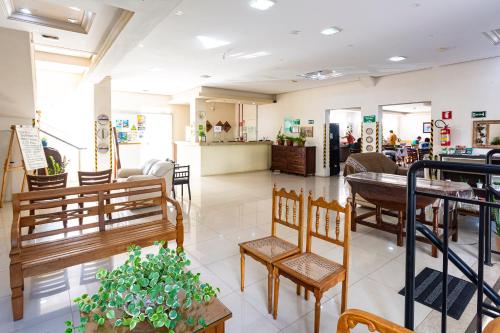 a store with tables and chairs in a room at Hotel Excelsior in Poços de Caldas