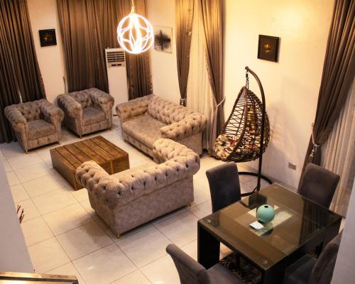 a living room with couches and a table at 4 bedroom fully detached duplex in Lekki Lagos in Maiyegun