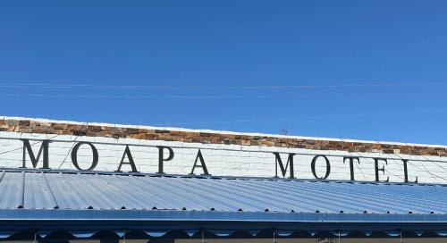 a sign on the top of a building with the words at Moapa Motel in Moapa