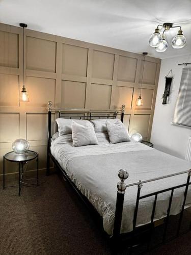 a bedroom with a large bed with a large headboard at Luxury Accommodation Denton in Denton