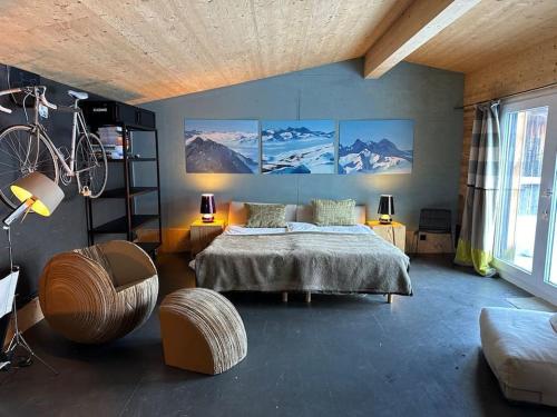 a bedroom with a bed and a bicycle on the wall at Out of the Box in Gsteig