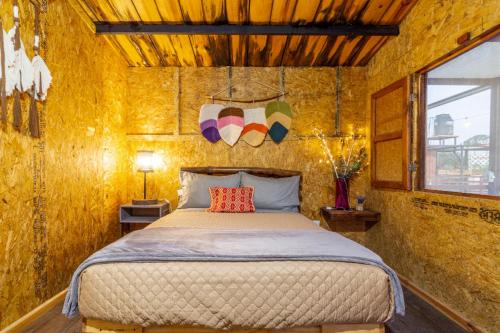 a bedroom with a bed in a yellow wall at Cabañas Miranda in La De