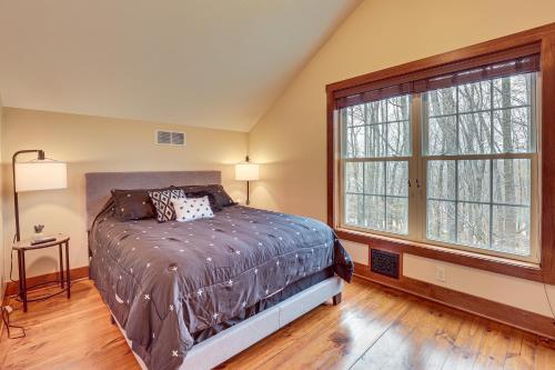 a bedroom with a bed and a large window at Happy Haven Hill Cabin with Patio and Fire Pit! in Dundee