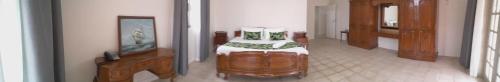 a room with a bed and a television in it at Yatu Lau Lagoon Resort Fiji in Pacific Harbour