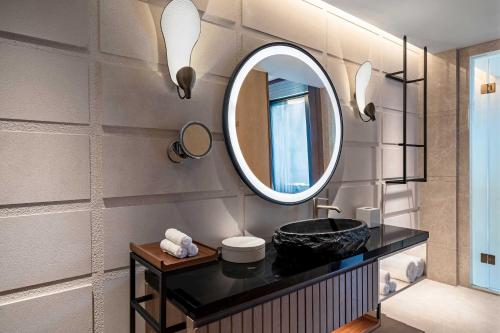 a bathroom with a sink and a mirror at The Westin Nanjing Resort & Spa in Nanjing