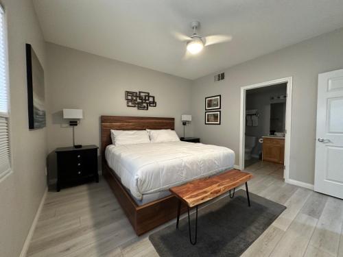 a bedroom with a bed and a table in it at Golfer’s Oasis Condominium at Hawk Ridge in Mesquite