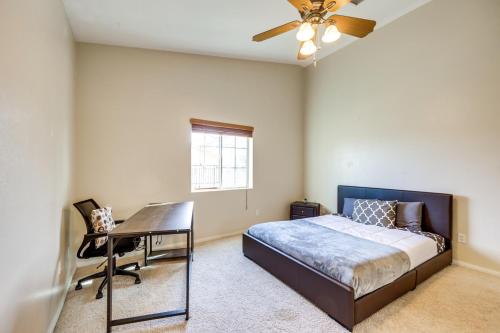 a bedroom with a bed and a desk and a ceiling fan at Joshua Tree Area Vacation Rental about 12 Mi to Park! in Yucca Valley