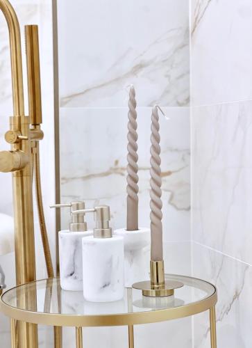 a gold and white bathroom with a glass table with candles at Apartamento Los Burgueses in Teruel