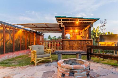 a patio with a chair and a table and a bench at Cabañas Miranda in La De