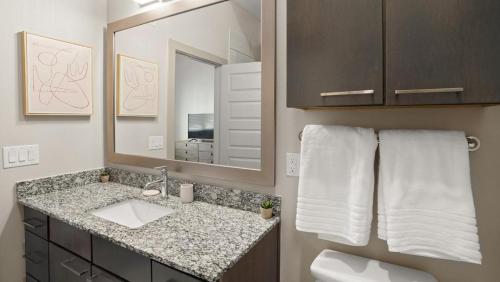 a bathroom with a sink and a mirror at Landing Modern Apartment with Amazing Amenities (ID3691X72) in Austin