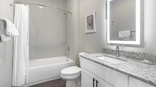 a white bathroom with a toilet and a sink at Landing Modern Apartment with Amazing Amenities (ID5350X87) in Warrenville