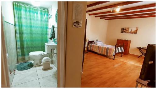 a bathroom with a toilet and a bed in a room at ENHEBRA HOUSE in Lima