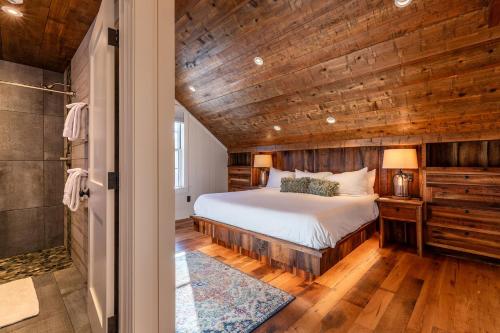 a bedroom with a bed and a wooden ceiling at The Barnstead Inn in Manchester Center