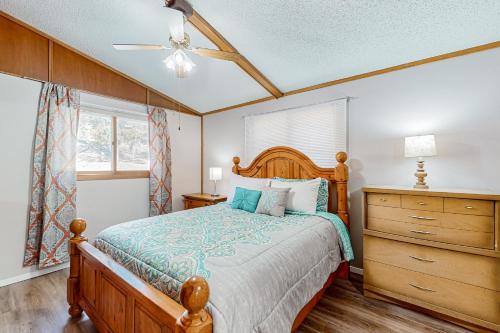 a bedroom with a wooden bed and a dresser at The Lost Bridge Lakehouse in Garfield