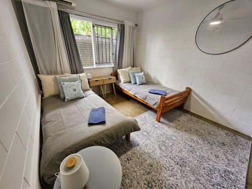 a small room with a bed and a window at Prime location: Just steps away from Oxford Street in Brisbane