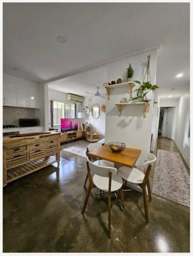 a kitchen with a table and chairs in a room at Prime location: Just steps away from Oxford Street in Brisbane