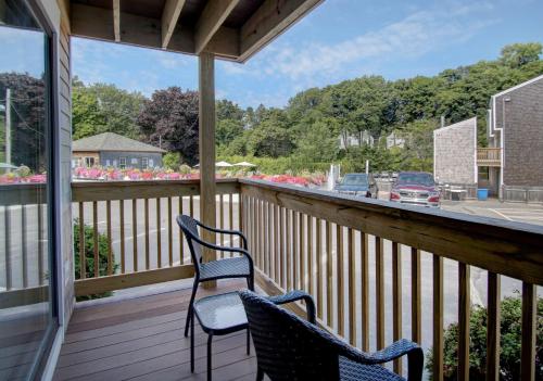 two chairs on a porch with a view of a street at Aspinquid Resort in Ogunquit