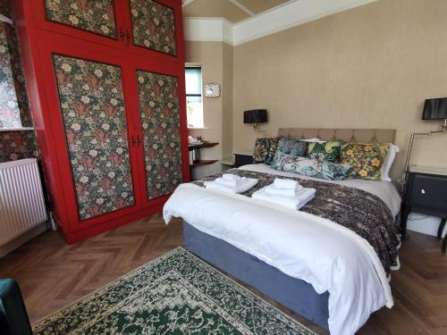sypialnia z łóżkiem i czerwonymi drzwiami w obiekcie Woodside House w mieście Bexhill