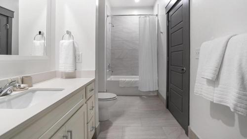 a white bathroom with a toilet and a shower at Landing Modern Apartment with Amazing Amenities (ID5175X53) in Charlotte