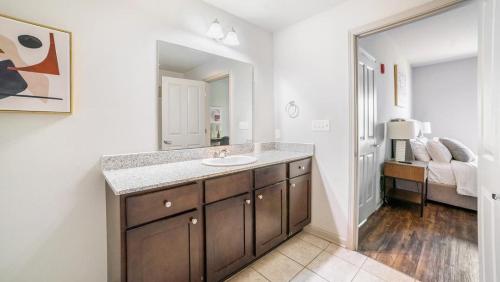 La salle de bains est pourvue d'un lavabo et d'un miroir. dans l'établissement Landing Modern Apartment with Amazing Amenities (ID8014X44), à Covington