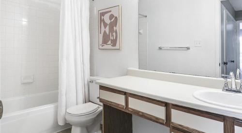 a white bathroom with a toilet and a sink at Landing Modern Apartment with Amazing Amenities (ID7025X65) in Cincinnati