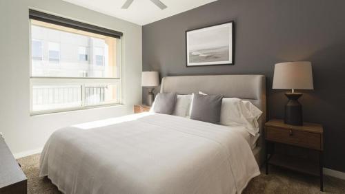 a bedroom with a white bed and a window at Landing Modern Apartment with Amazing Amenities (ID8359X76) in Newport