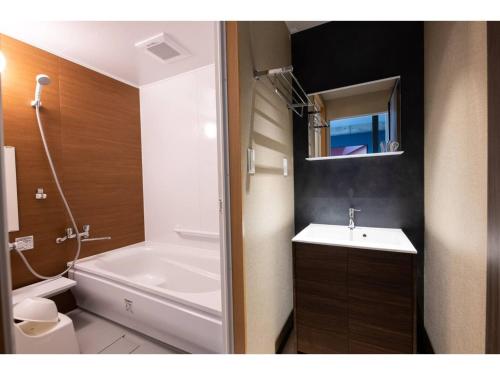 a bathroom with a tub and a sink and a toilet at Volcano - Vacation STAY 89665 in Kagoshima