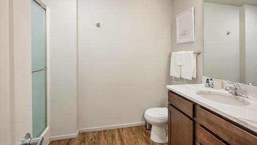 a bathroom with a toilet and a sink and a shower at Landing Modern Apartment with Amazing Amenities (ID8368X66) in Omaha