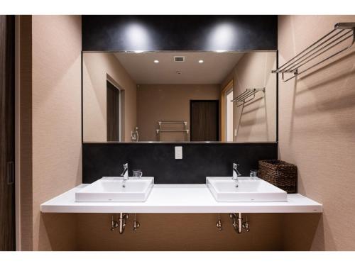 a bathroom with two sinks and a large mirror at Volcano - Vacation STAY 89674 in Kagoshima