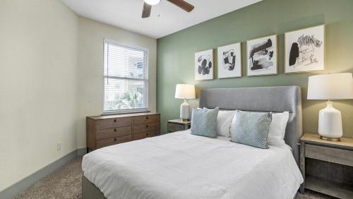 ein Schlafzimmer mit einem Bett, zwei Lampen und einem Fenster in der Unterkunft Landing Modern Apartment with Amazing Amenities (ID7650X68) in Dallas