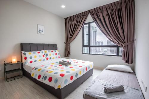 a bedroom with two beds and a window at A Lovely & Comfy Suite at Suasana Suites JB 11 in Johor Bahru