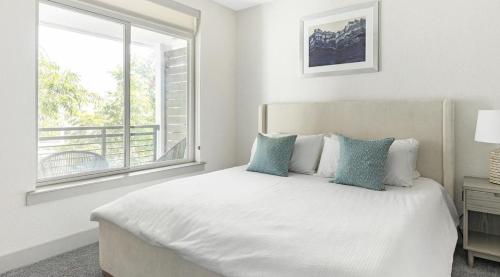 a white bedroom with a bed and a window at Landing Modern Apartment with Amazing Amenities (ID1374X218) in San Antonio