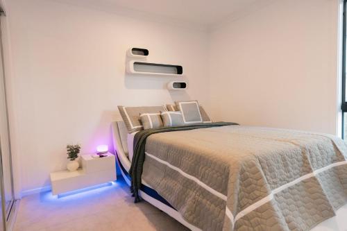 a bedroom with a bed in a white room at Ayubo in Apollo Bay