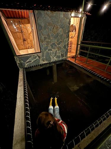 a couple of people are laying down in a tunnel at Luz de Luna Glamping in Anolaima