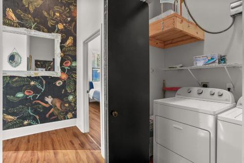 a laundry room with a washer and dryer at Stunning 2-Bedroom Garden District Newly Renovated in New Orleans