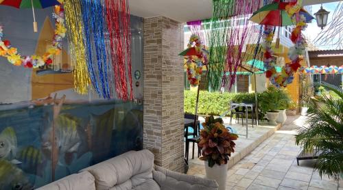 a living room with umbrellas hanging from the ceiling at Pousada Residência dos Sonhos in Porto De Galinhas