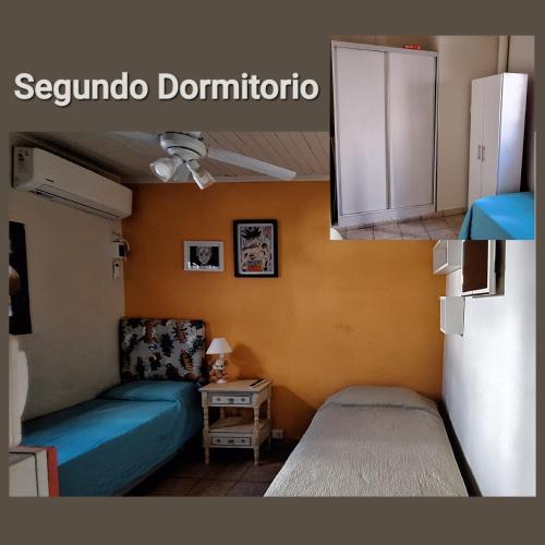Habitación pequeña con cama y mesa en Dpto 2 dorm Céntrico en Corrientes