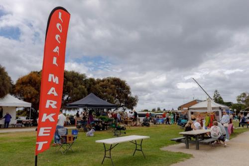 a sign in a park with a crowd of people at Ayubo in Apollo Bay