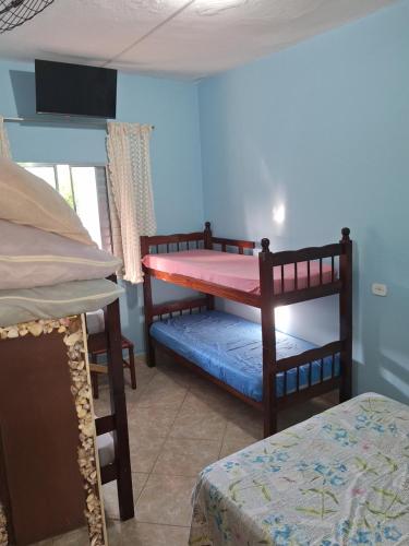 a bedroom with two bunk beds in a room at POUSADA BORBOLETA AZUL in Ilha Comprida
