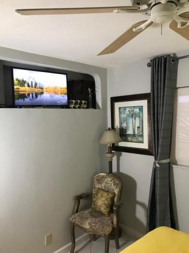 a room with a chair and a tv on the wall at Perfect get away from big city life in Freeport